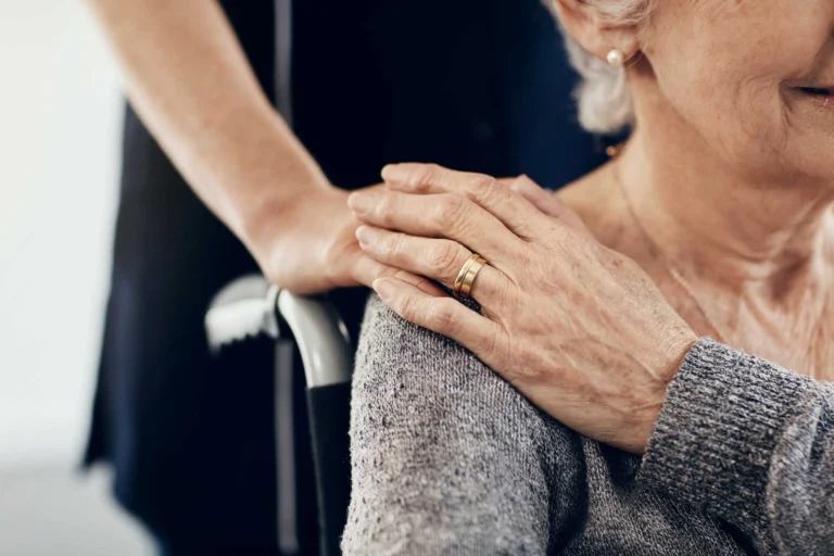 Cropped shot of a female caregiver comforting a senior woman