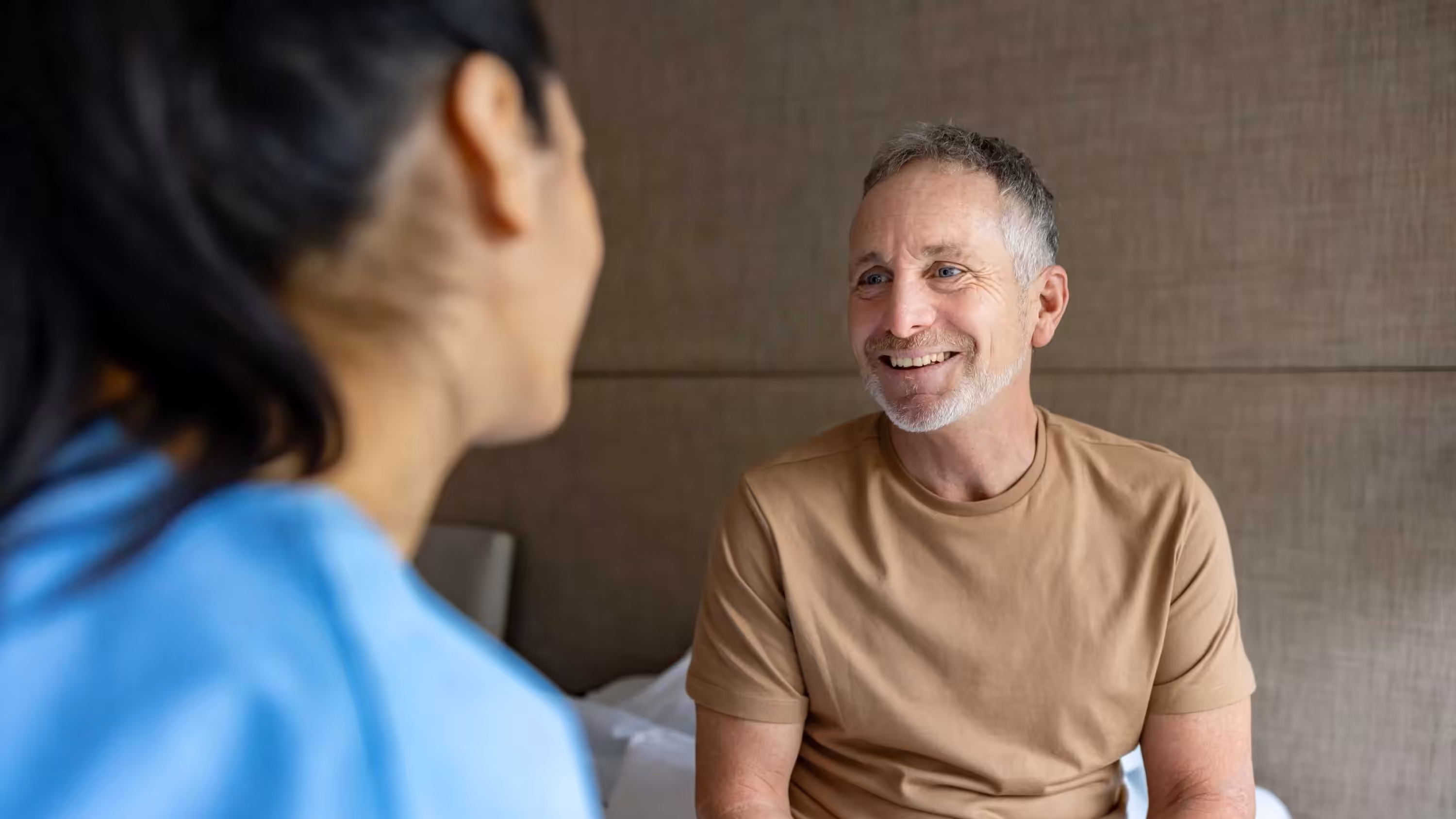 Mature man talking to a nurse in assisted living facility 16x9
