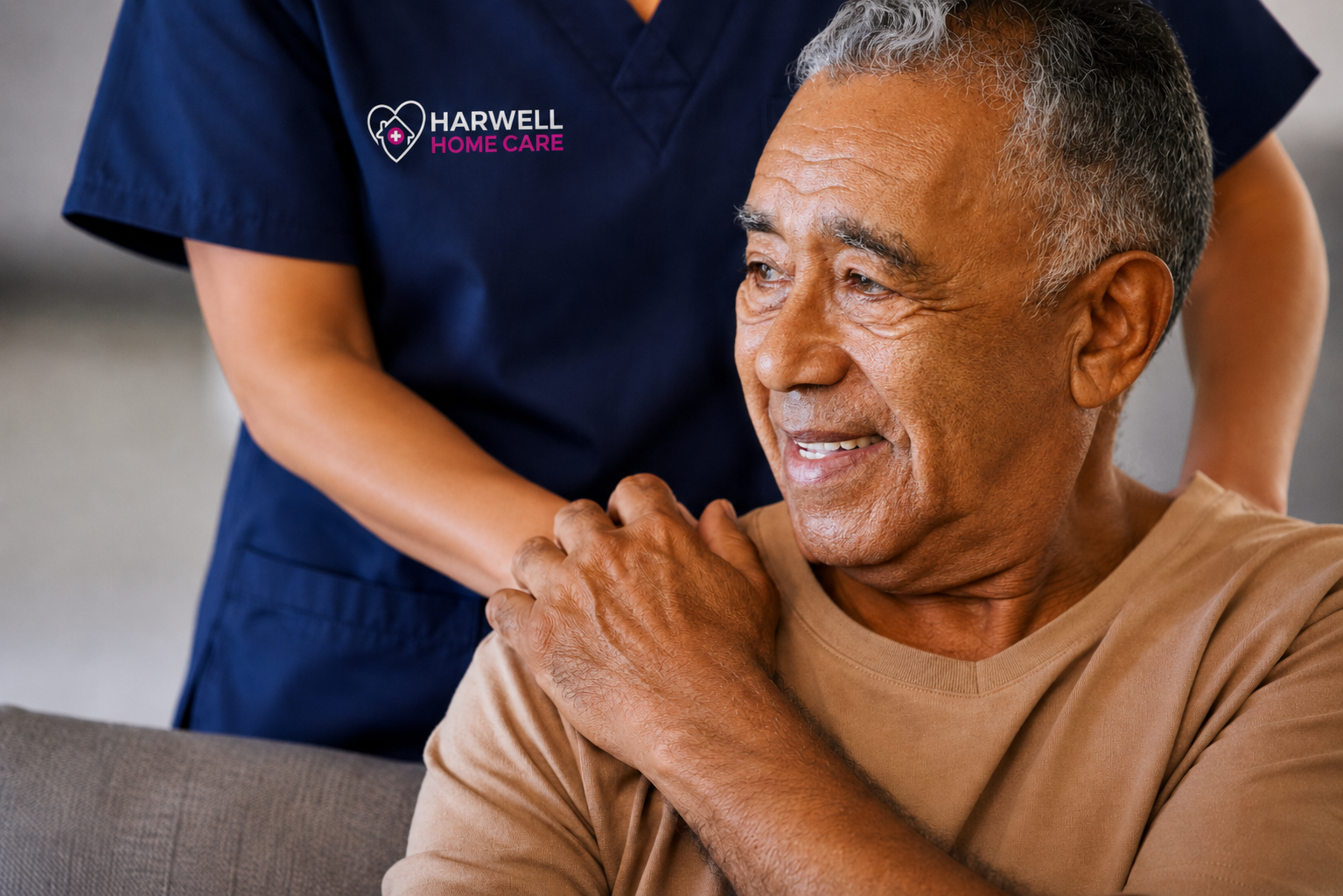 Harwell Home Care worker offering reassurance to a senior man during an in-home care visit.